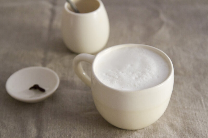 coffee with frothed milk in a white mug