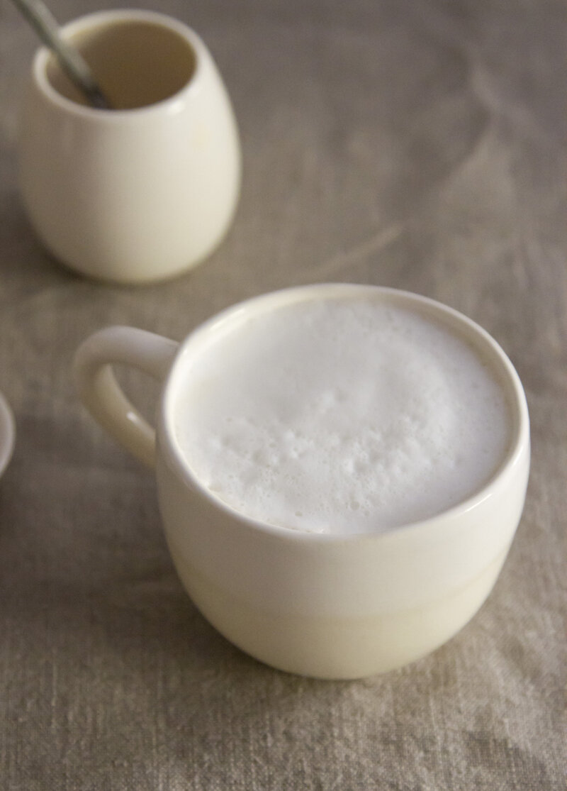 coffee with frothed milk in a white mug