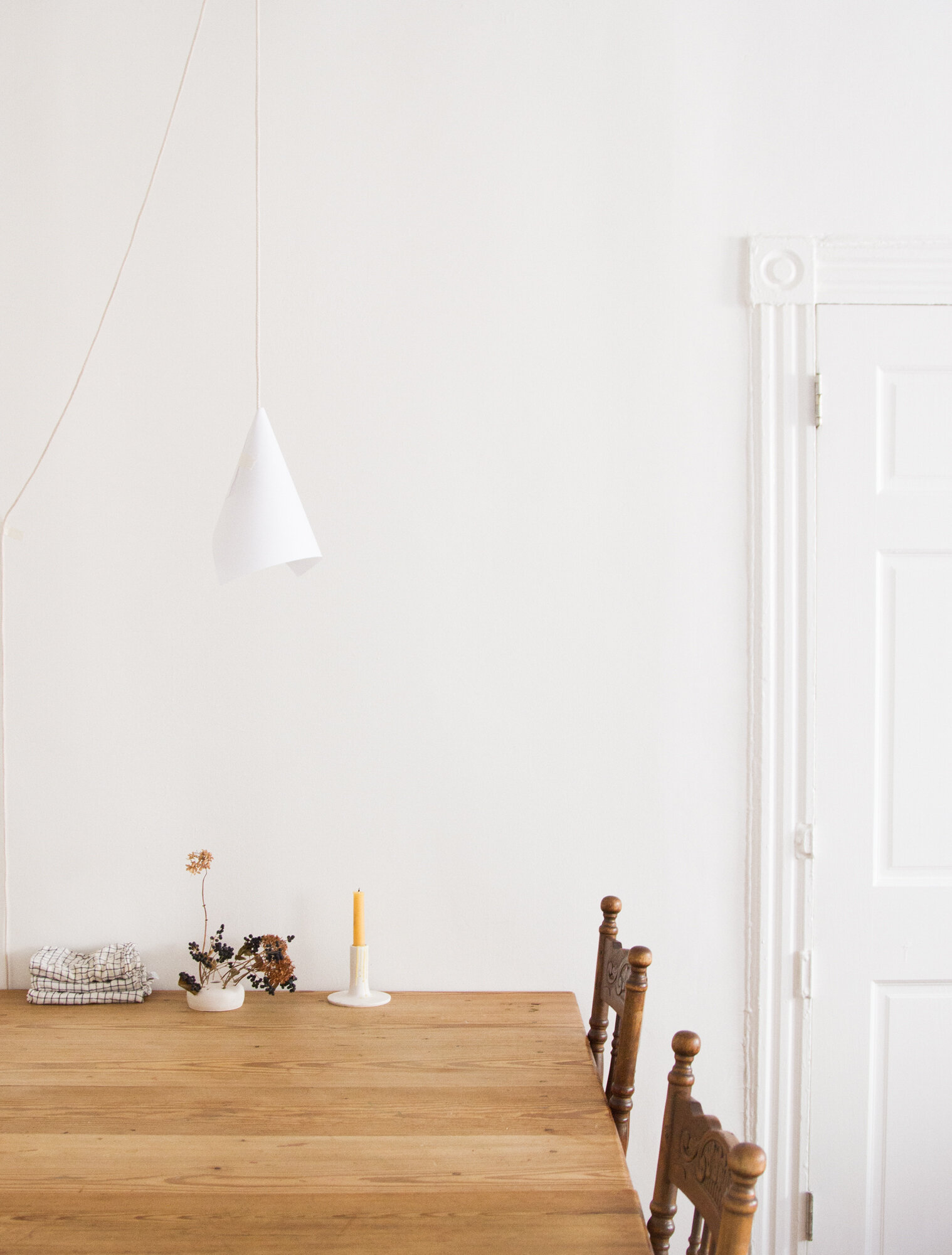 a paper and string lamp above a wooden table | reading my tea leaves